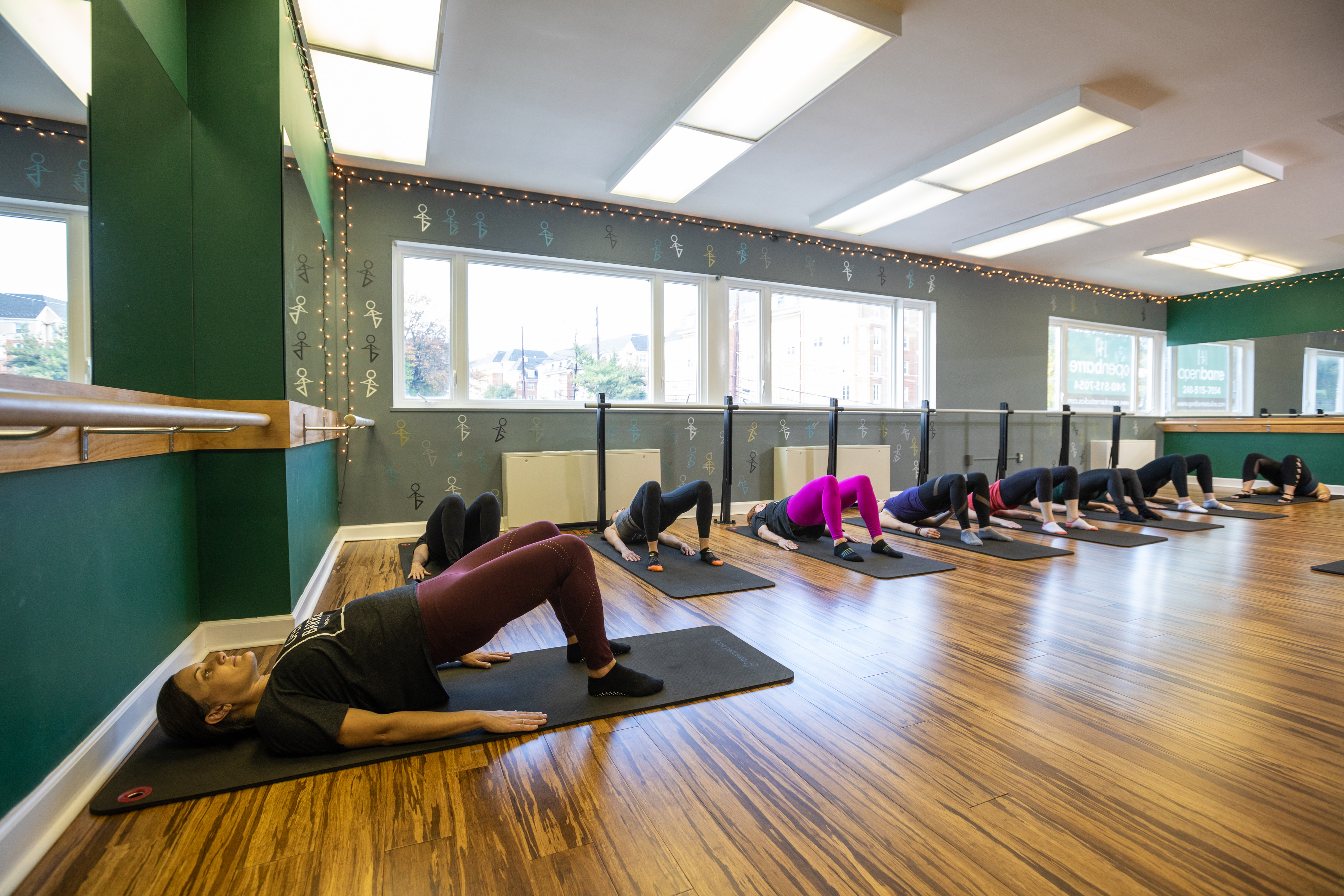 new moms in bridge position for Mom Strength post-natal class targeting diastasis recti abdominal separation via modified core work